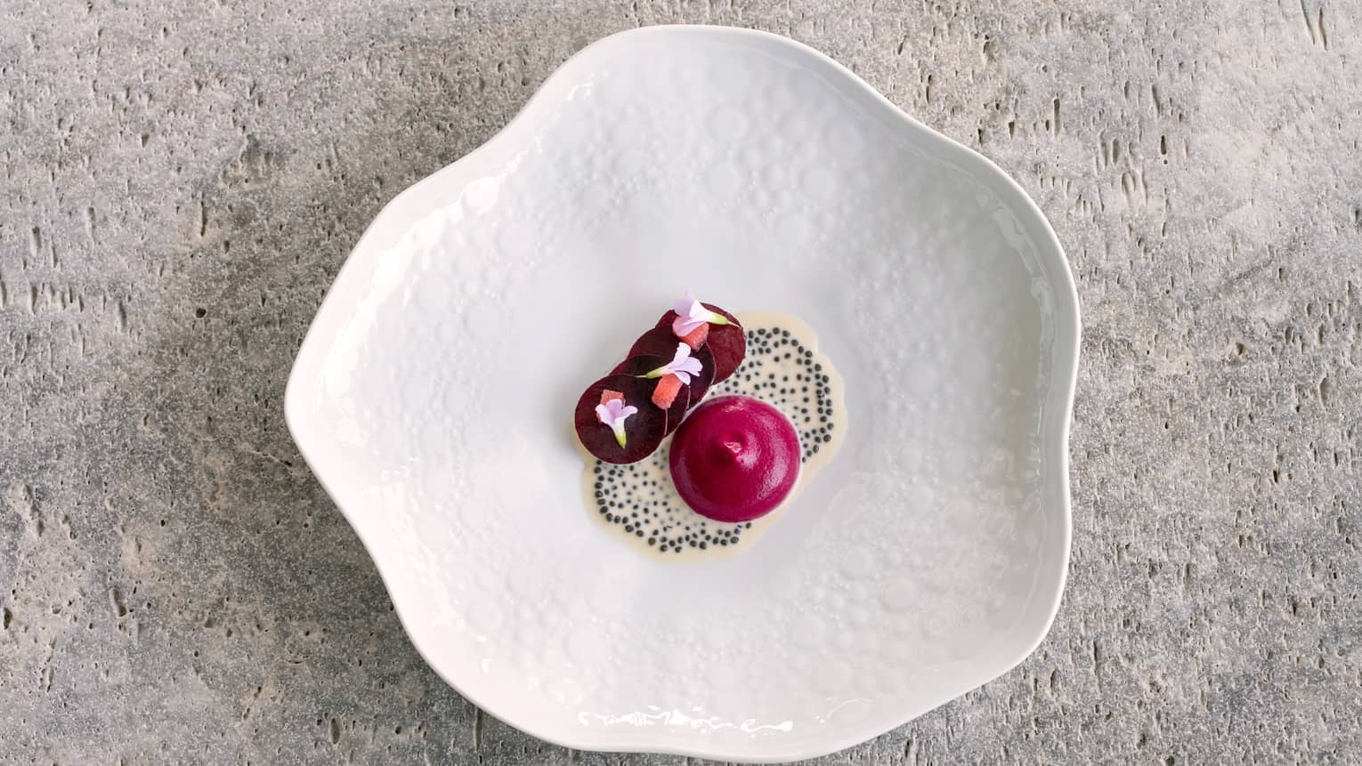 Langoustine Tartare with Beetroot Carpaccio and Champagne Sauce on scalloped round white dish