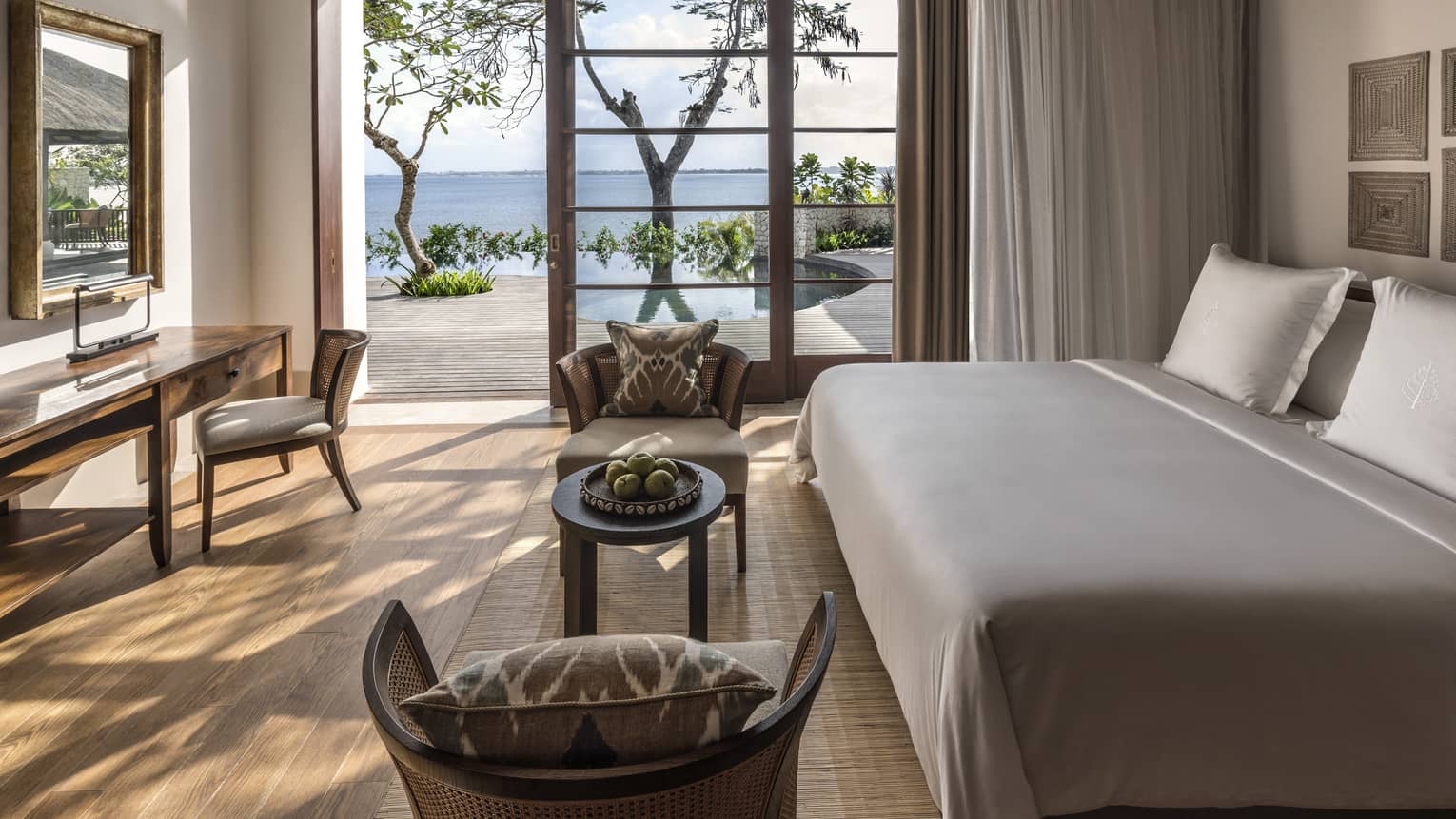 Imperial Villa Downstairs Bedroom with doors opened to a veranda overlooking the ocean