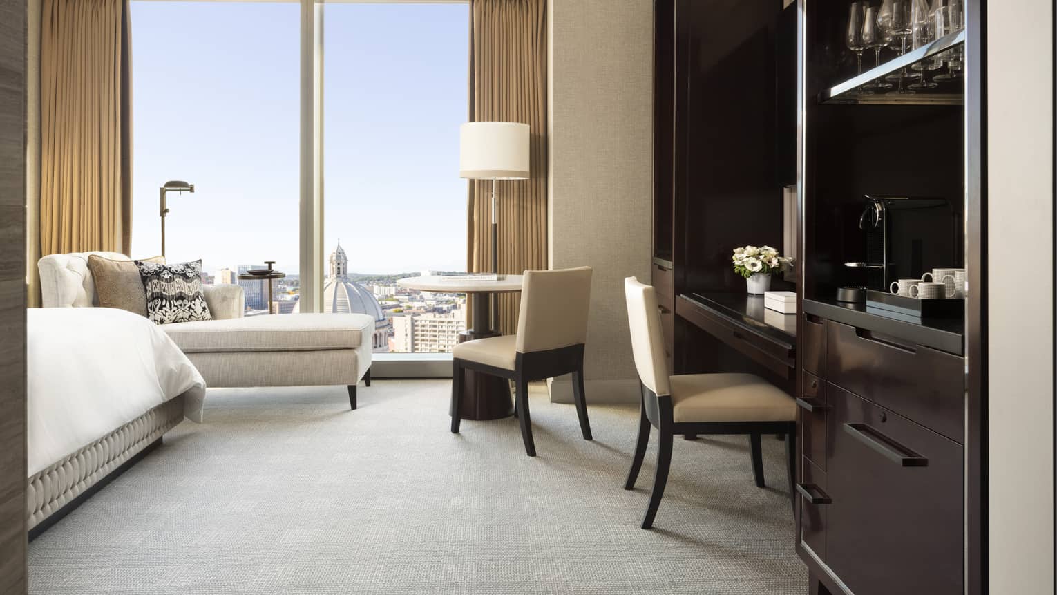 Built-in desk area in a guest room, with floor to ceiling windows overlooking Boston's Back Bay