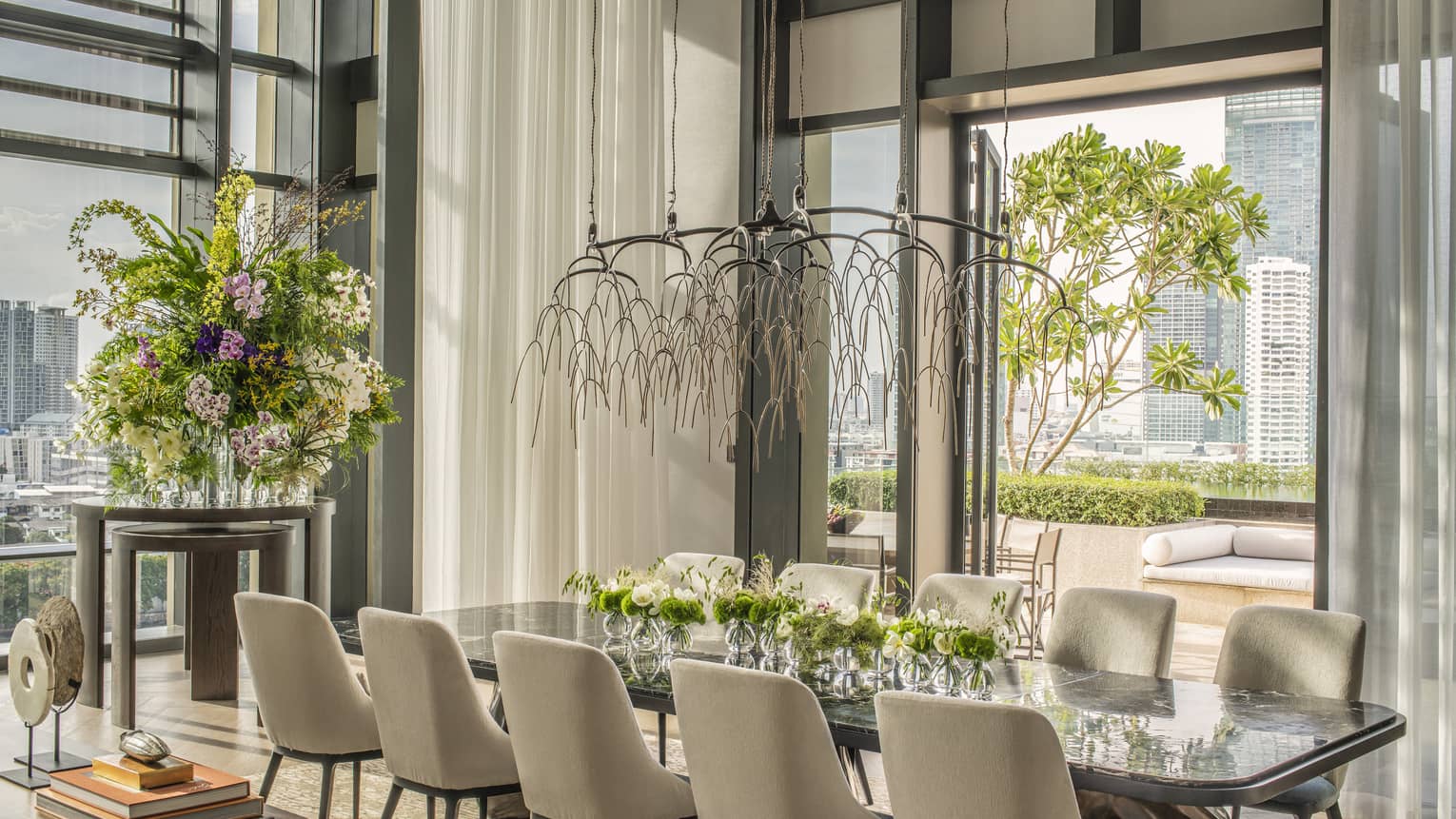 Dining table with 10 chairs, opening to a city-view terrace
