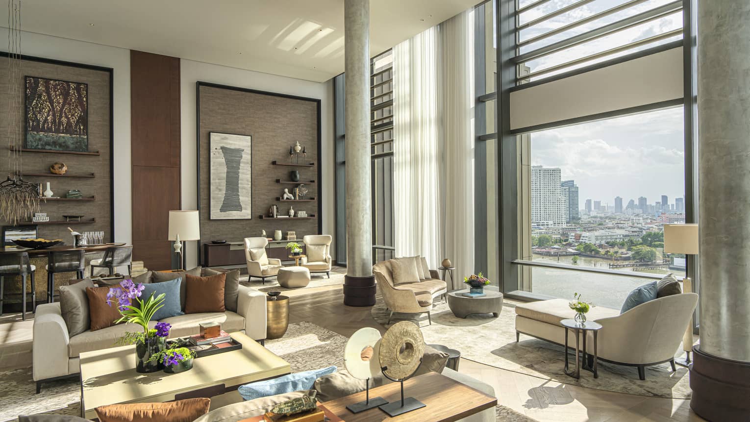 Lavish suite living area with window overlooking Bangkok river