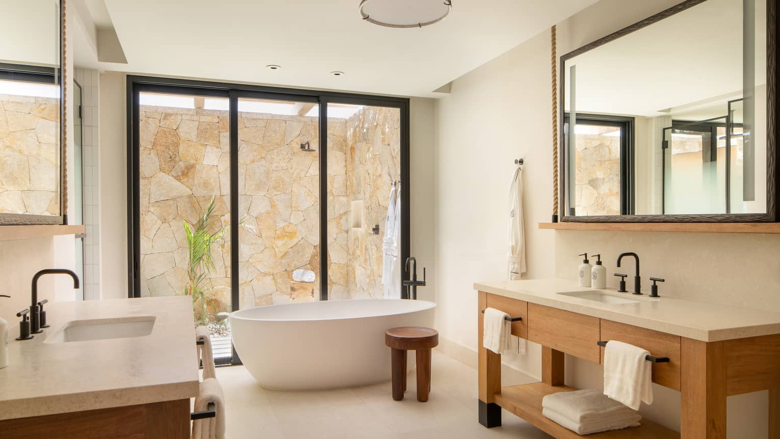Luxury resort bathroom with standalone tub and outdoor shower at Four Seasons Resort Cabo San Lucas