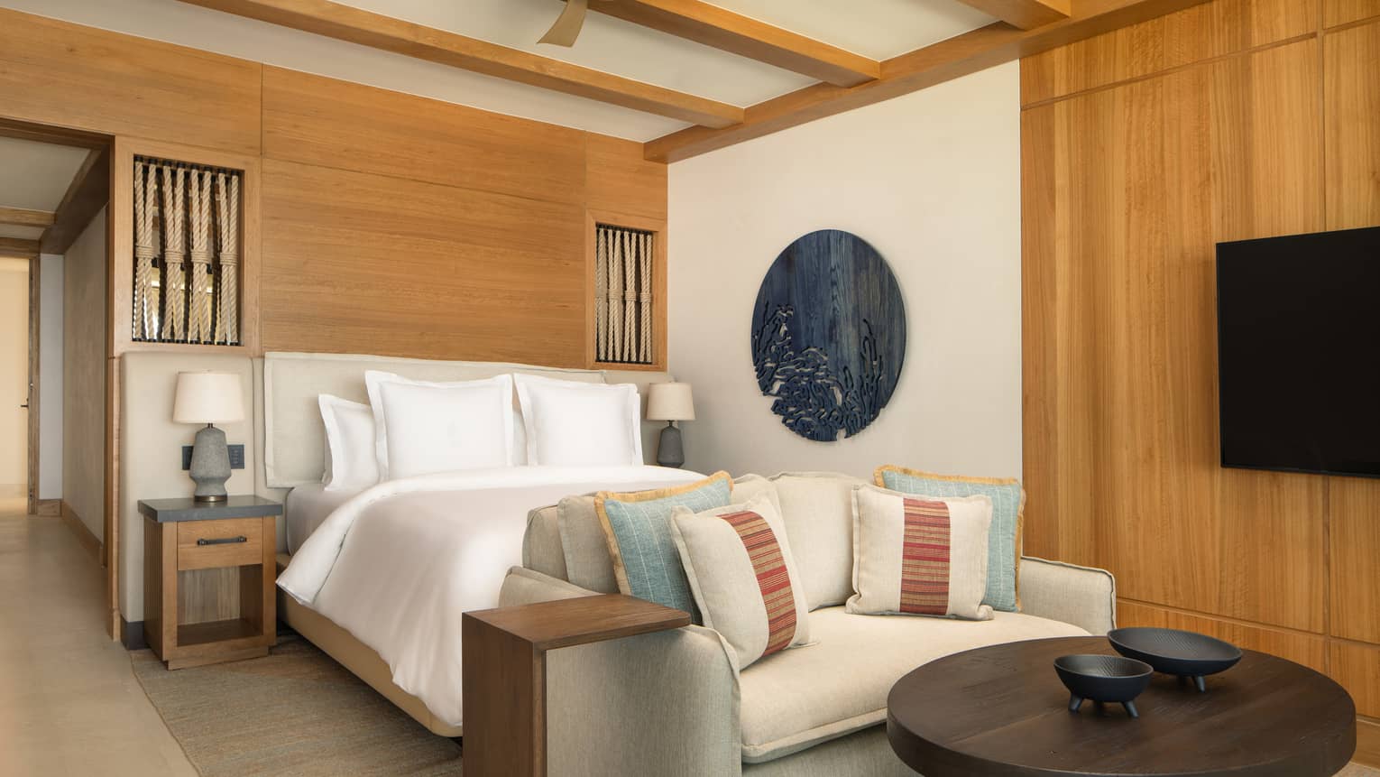 Oceanfront casita bedroom with king bed and sofa at Four Seasons Resort Cabo San Lucas