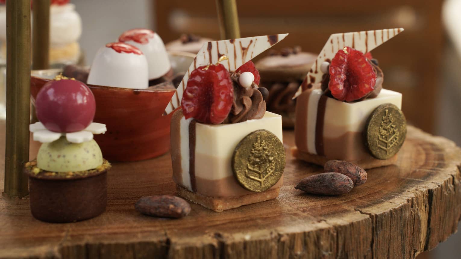 Gourmet sweets arranged on a wooden platter for afternoon tea