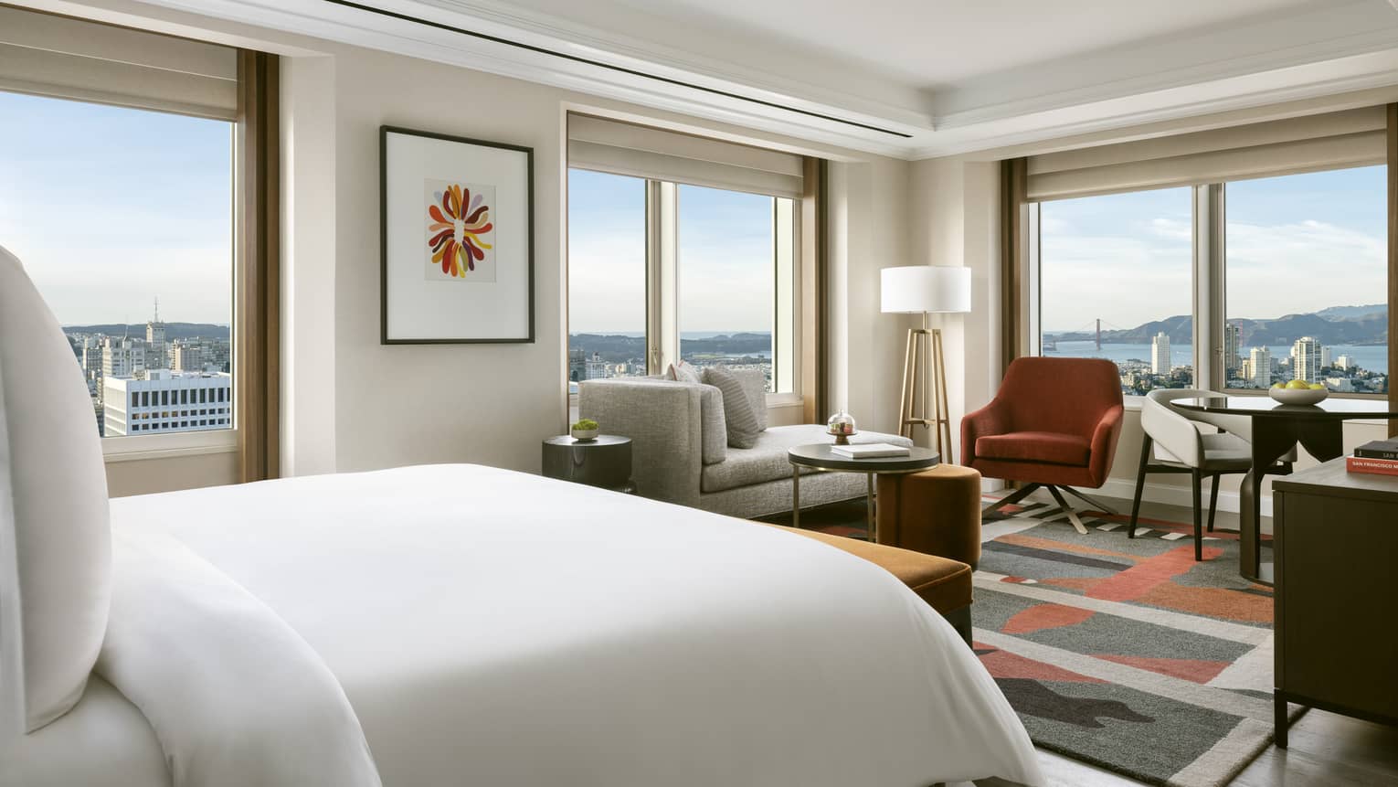 Modern hotel room with queen bed and corner views of San Francisco and bay