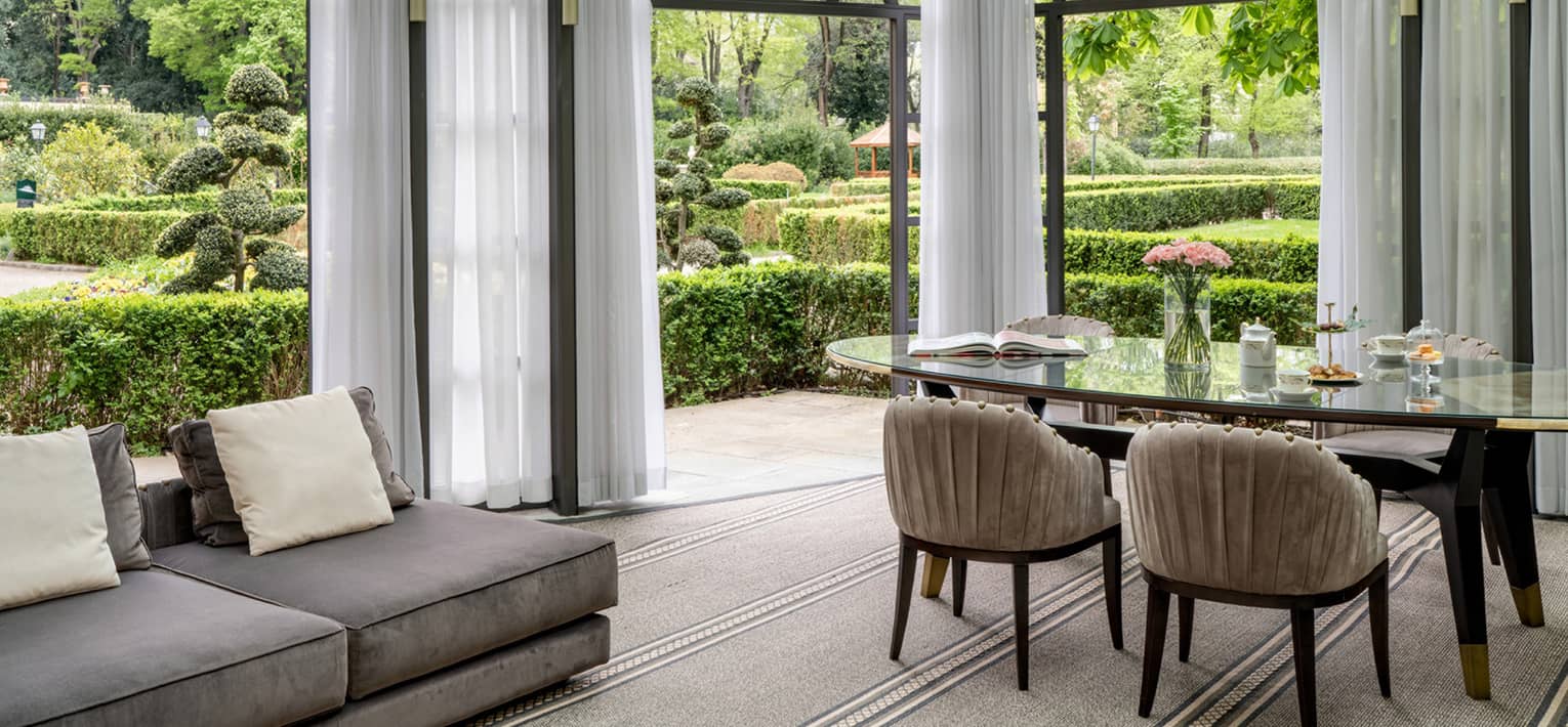 Living and dining area that opens to a lush garden