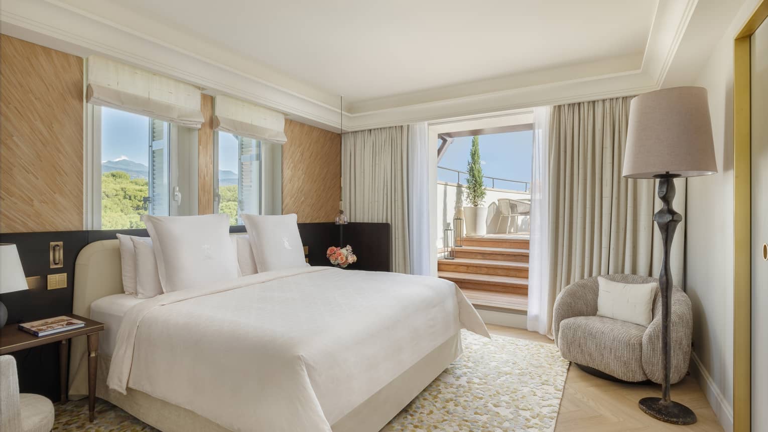 Luxury penthouse suite bedroom with king bed and walk-out terrace