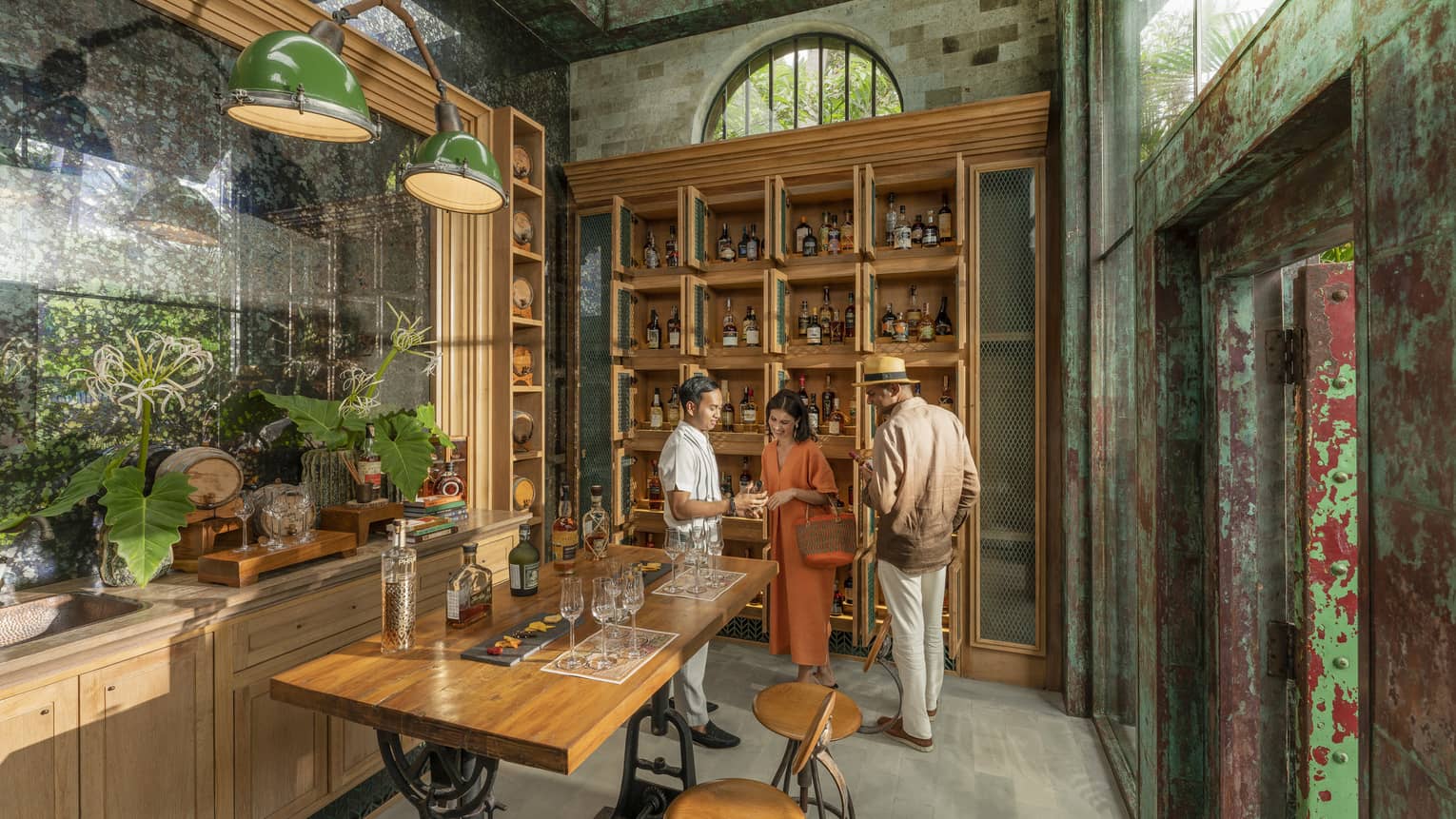 Male staff member offers samples to couple at Rum Vault