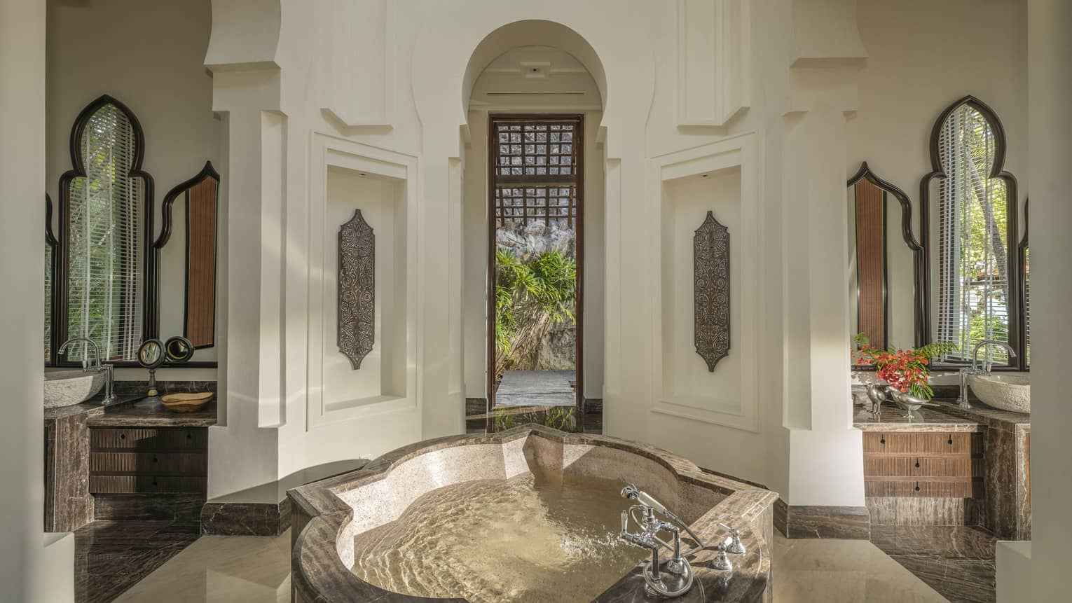 Opulent bathroom with intricate crown molding features and standalone tub