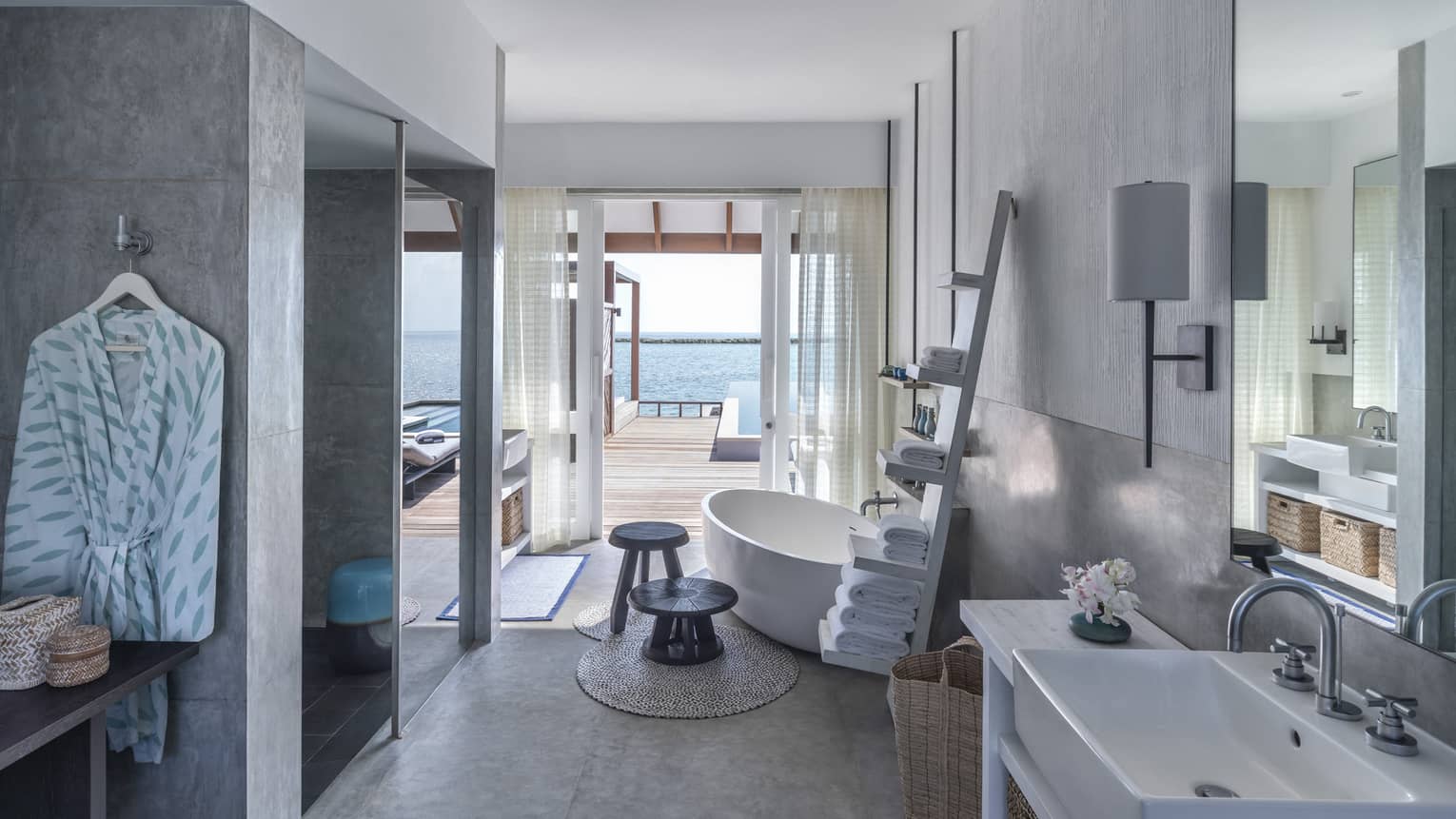 Sunrise Water Villa with Pool bathroom, large soaking tub, towel rack, doorway to deck with pool