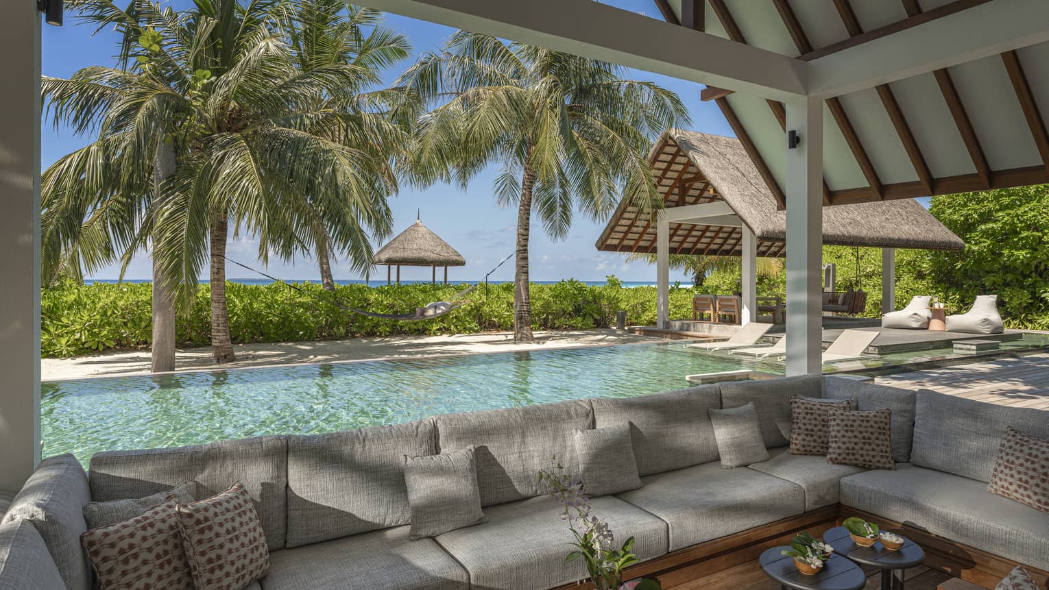 Outdoor, covered lounge by a pool