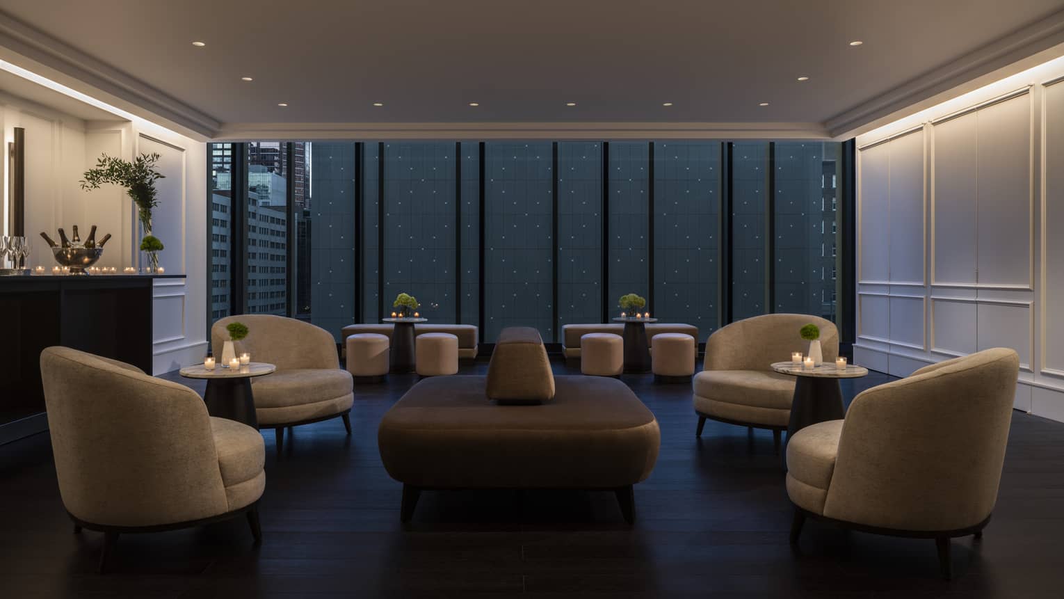 Curved modern club chairs and a central bench fill the dimly lit Hotel foyer