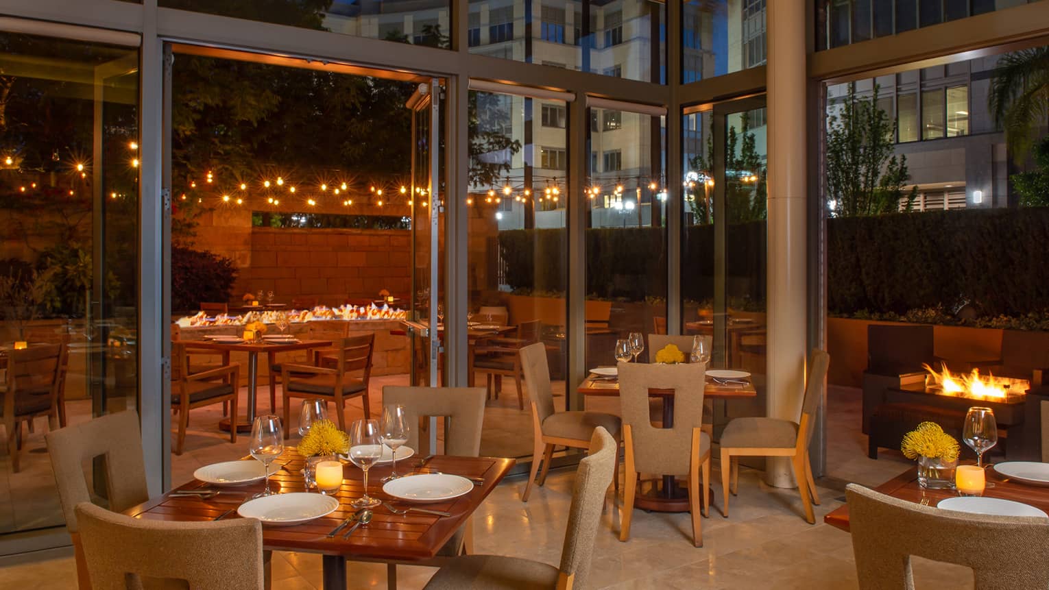A restaurant with large glass windows and a warm atmosphere.