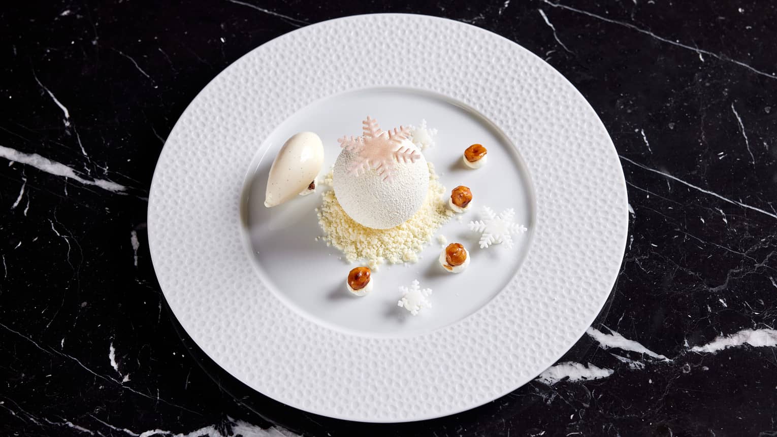 Vanilla mousse on a white plate.