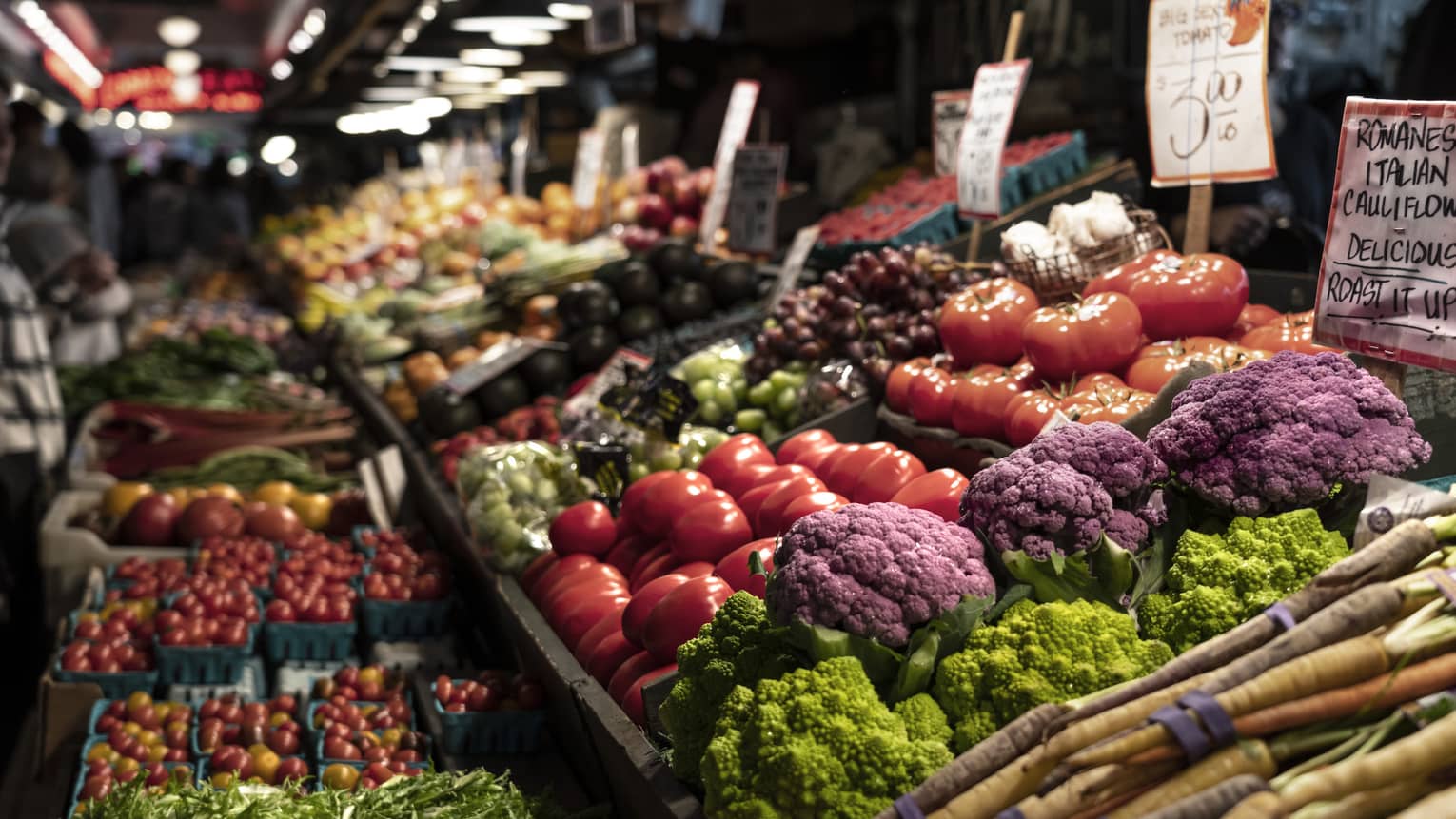 A picture of a vegetable stand in a dimly lit space. 