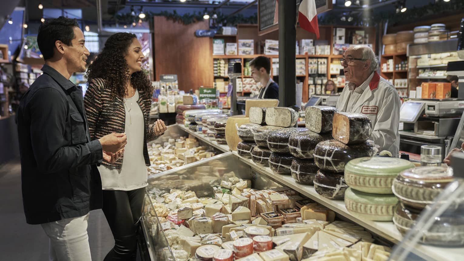 Guests sample and choose from an array of cheeses in at Olympic Food and Cheese in Toronto