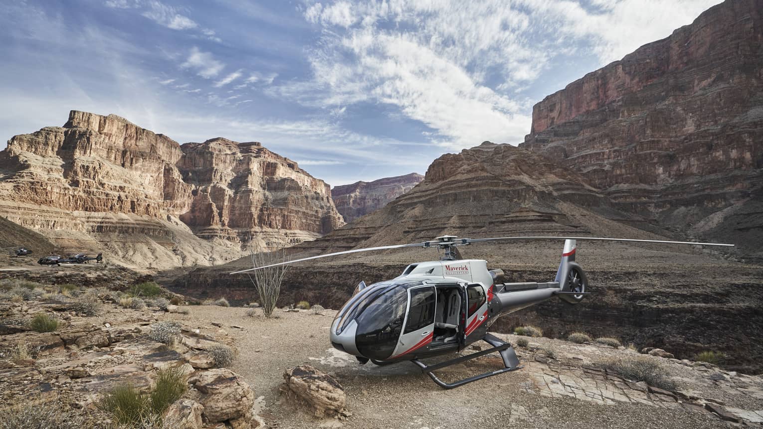 Helicopter sits on rock ledge at Grand Canyon