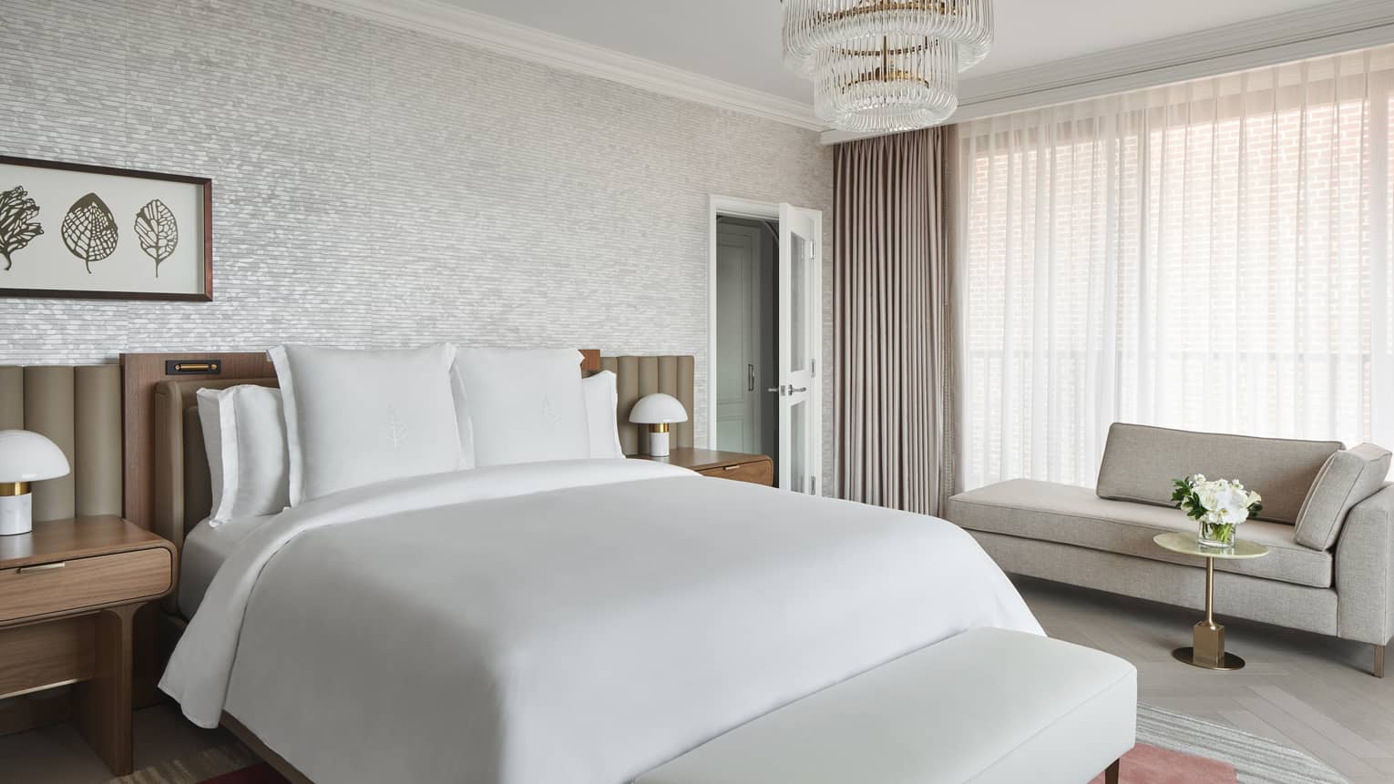 Elegant white and taupe bedroom with king bed and chandelier. Georgetown Suite at Four Seasons Hotel Washington, DC