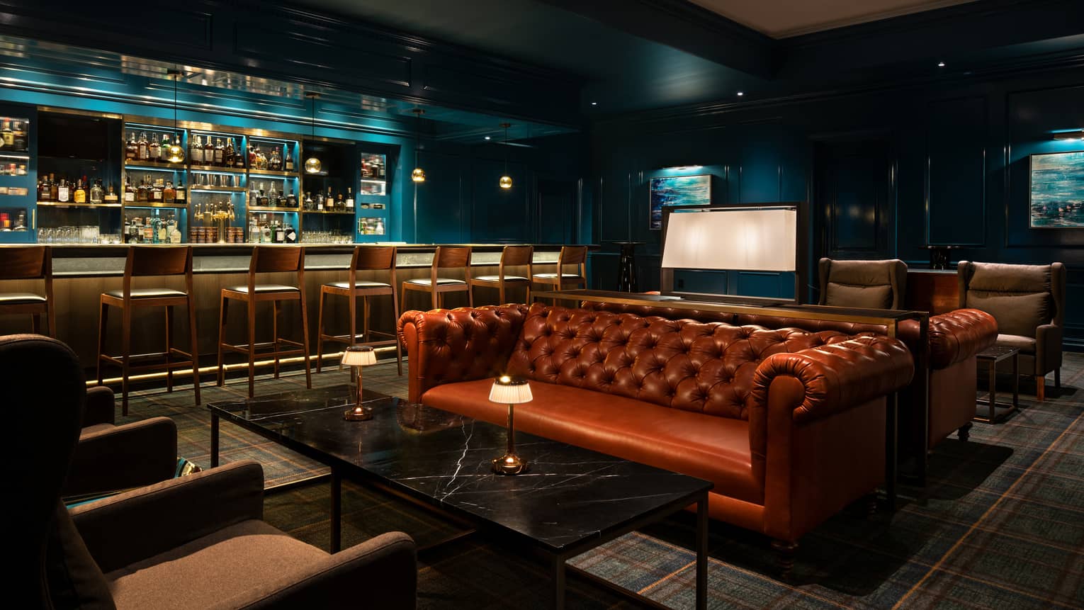 Tufted leather sofa at the Prosperous Penny bar area