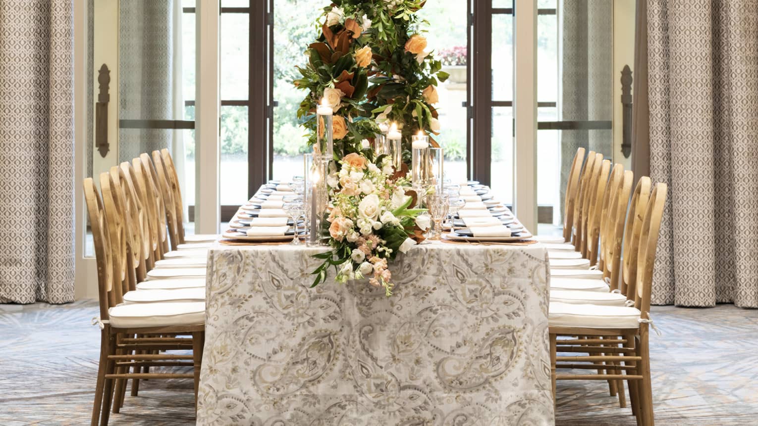 Elegant wedding dining table with candles, flowers under arched doorway