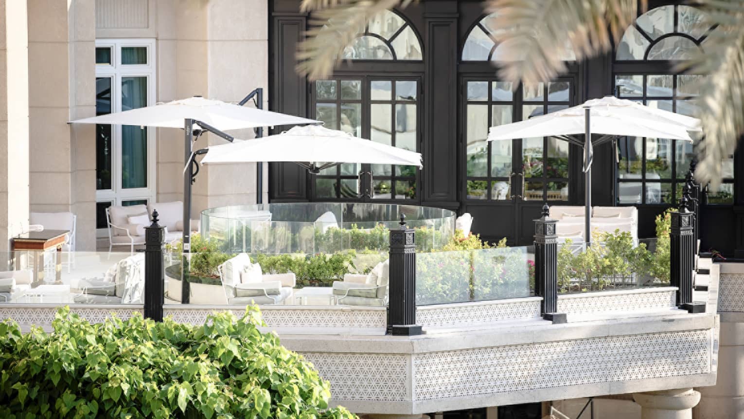 Seasons Tea Lounge patio lounge sofas under white umbrellas