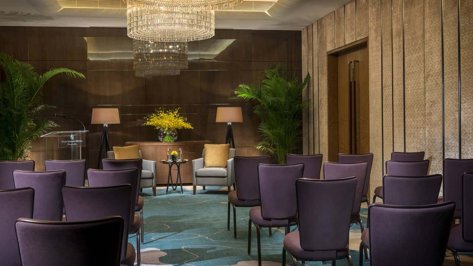 Sapphire Meeting Room conference, rows of purple chairs facing two armchairs