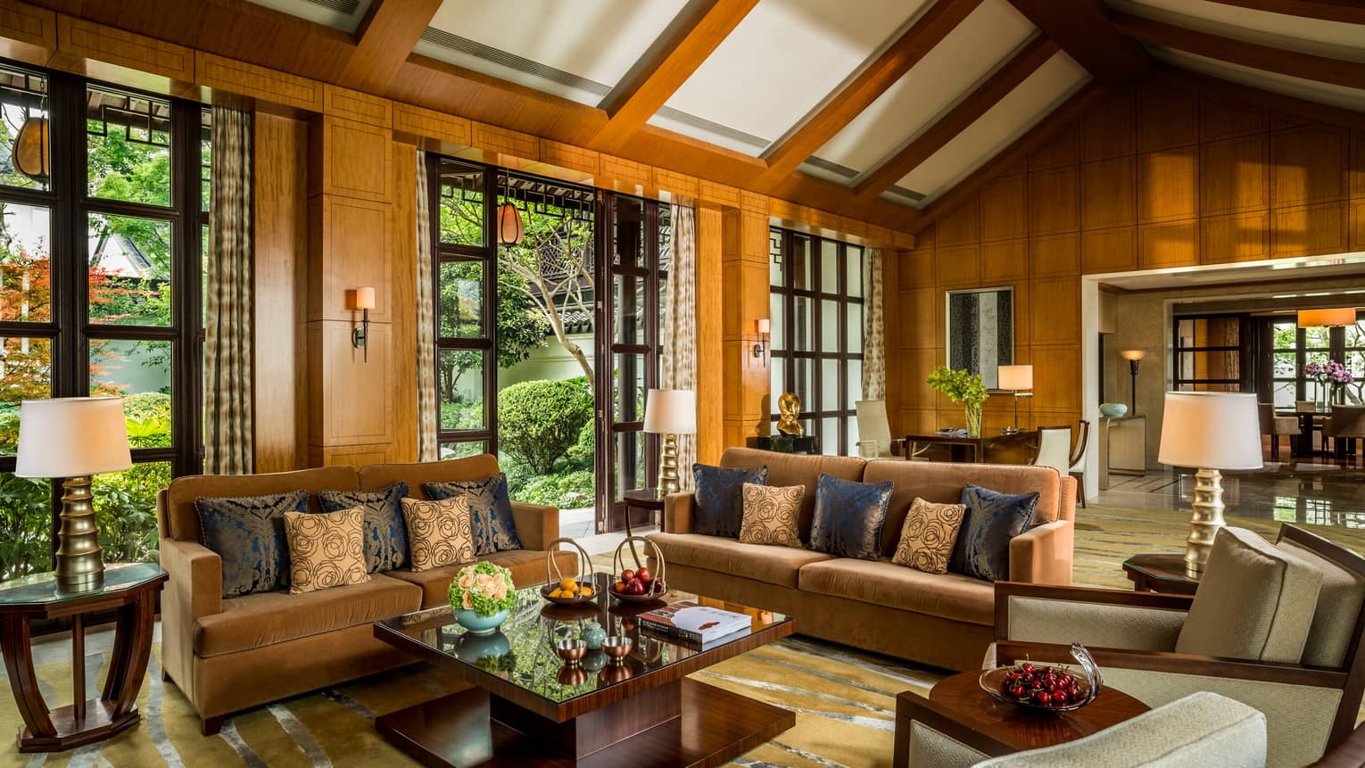 Presidential Villa with two orange velvet sofas, chairs around modern wood table