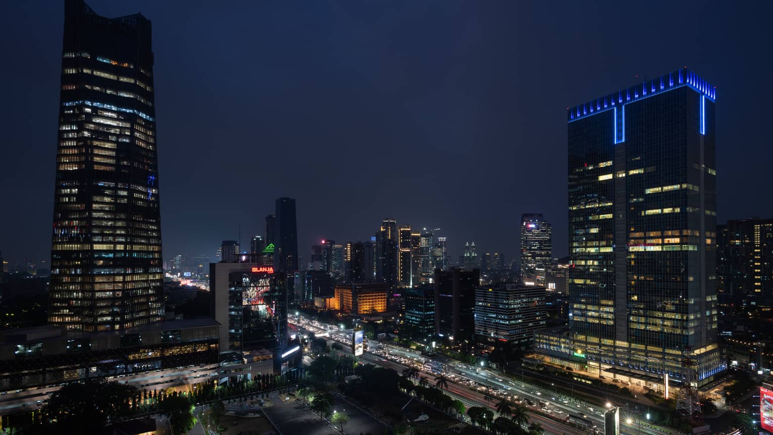 Jakarta city buildings, highway with lights at night 