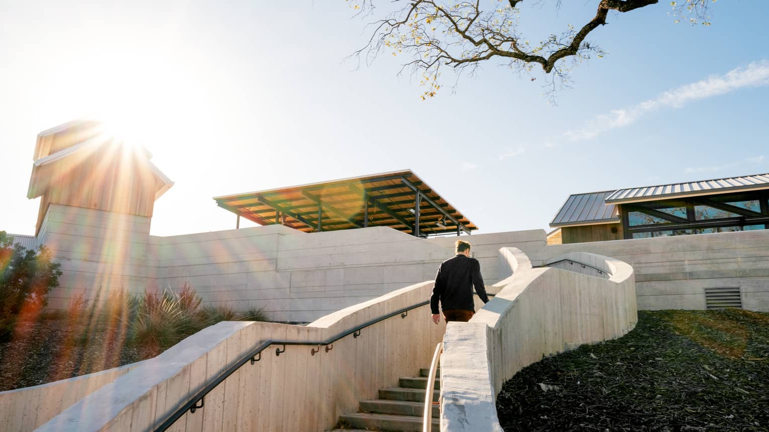 A resort team member walking up steps outside.