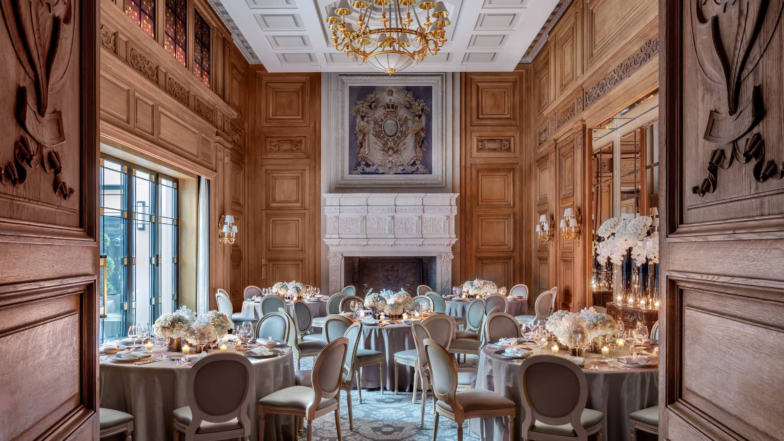 Salon Louis XIII room banquet, elegant carved wood doors, walls and ceiling, painting over mantle 