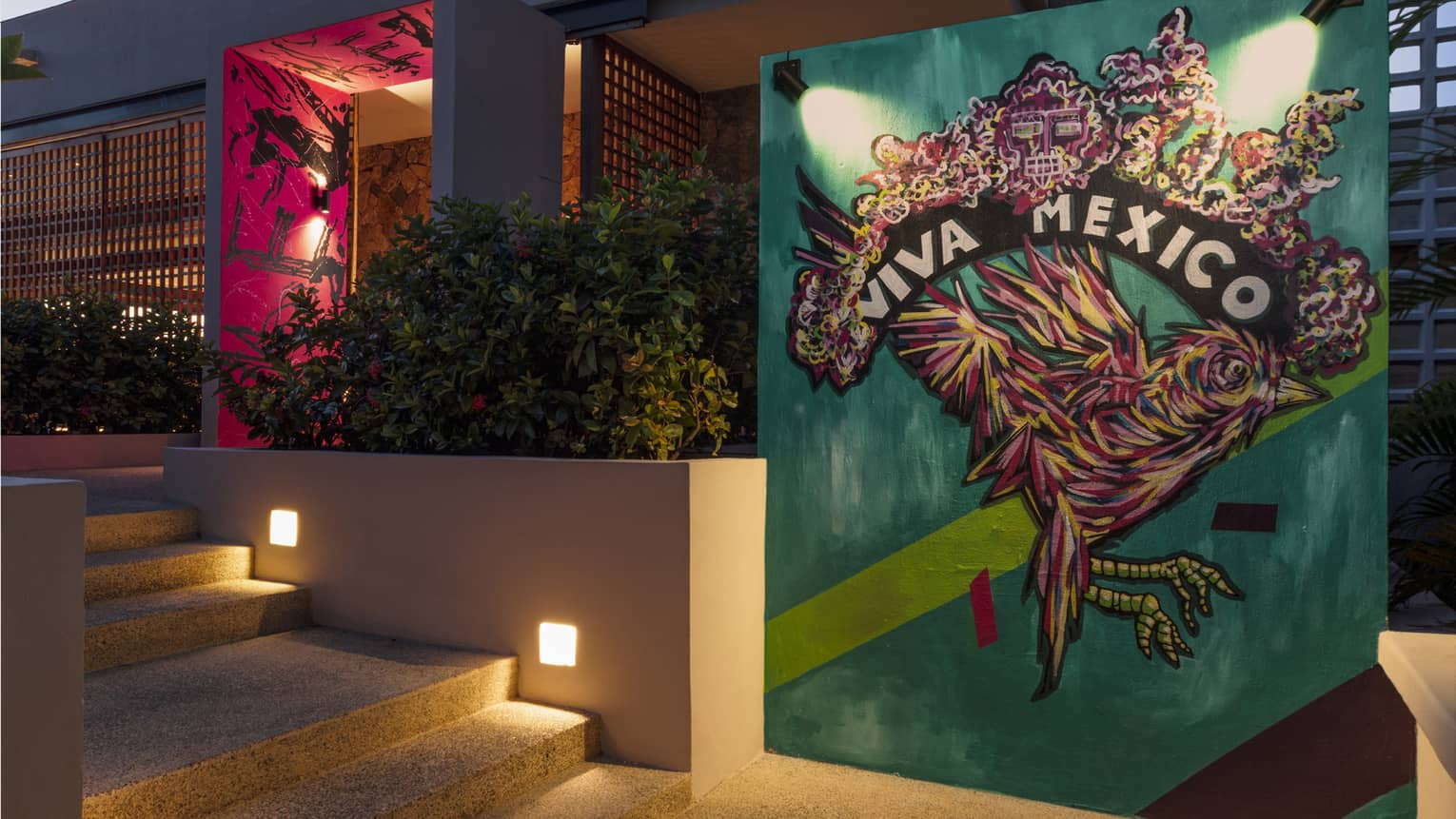 Wall art outside a bar that is of a bird on a teal background.