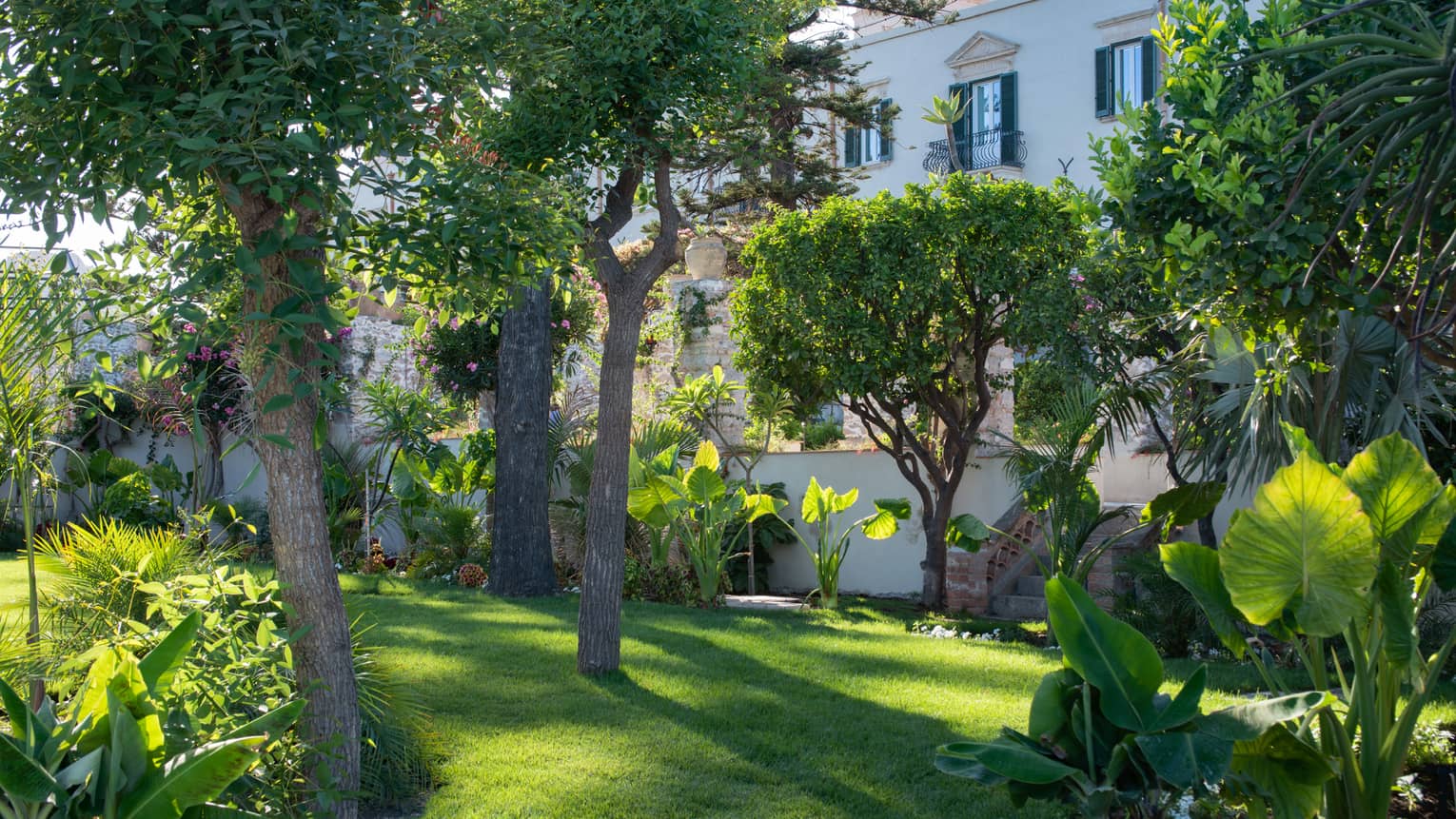 Taormina's onsite gardens with flowering trees, shrubs and bushes on a sunny day