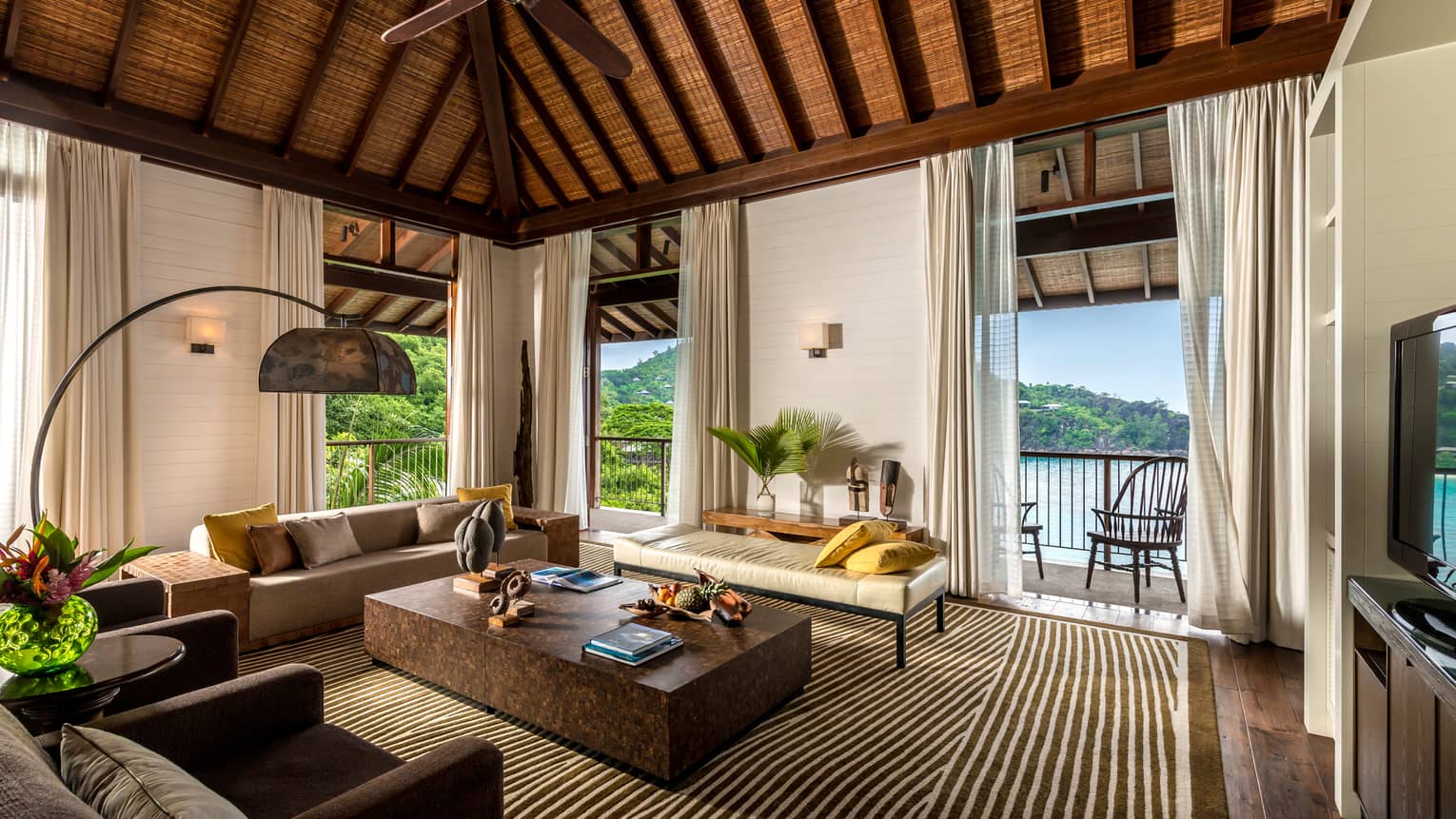 Five-Bedroom Residence Villa living room with sofas, long white curtains, square coffee table