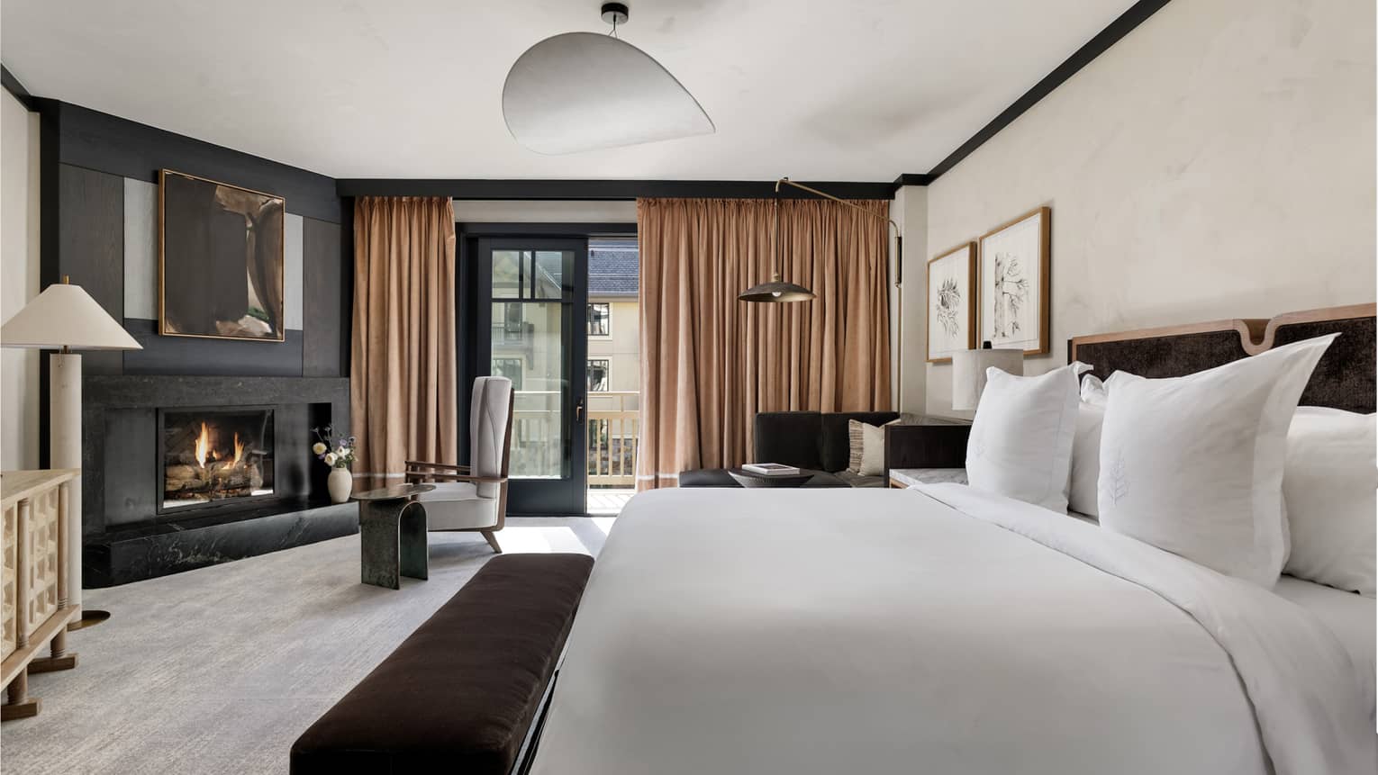 Contemporary bedroom with king bed, gas-burning fireplace and walk-out balcony at Four Seasons Vail