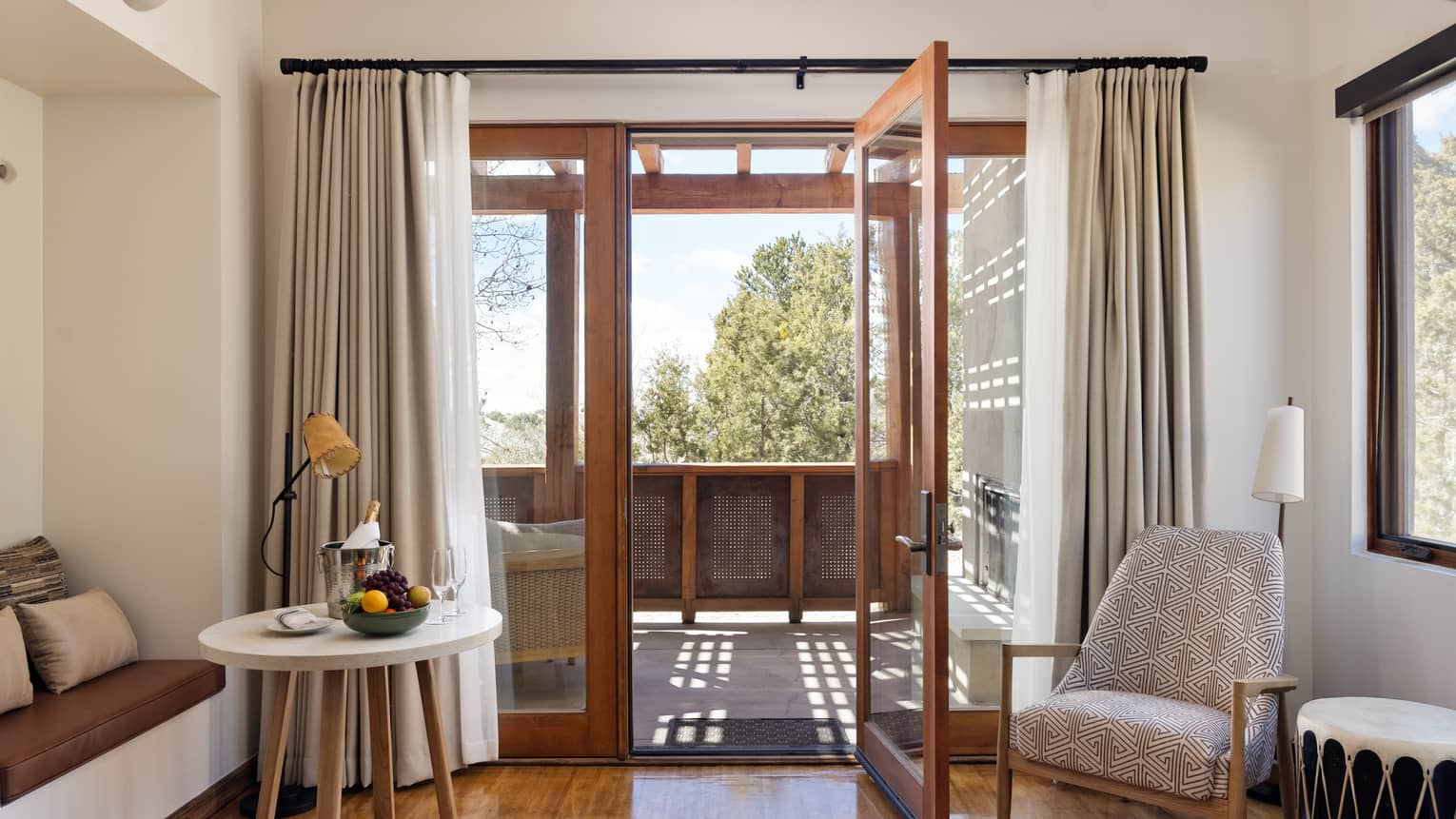 Hotel suite living room with walk-out terrace at Four Seasons Resort Santa Fe