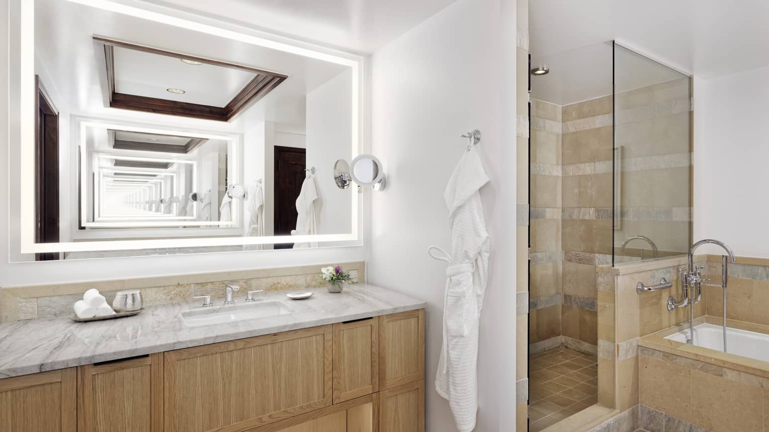 Bathroom with wood and marble vanity, shower and tub