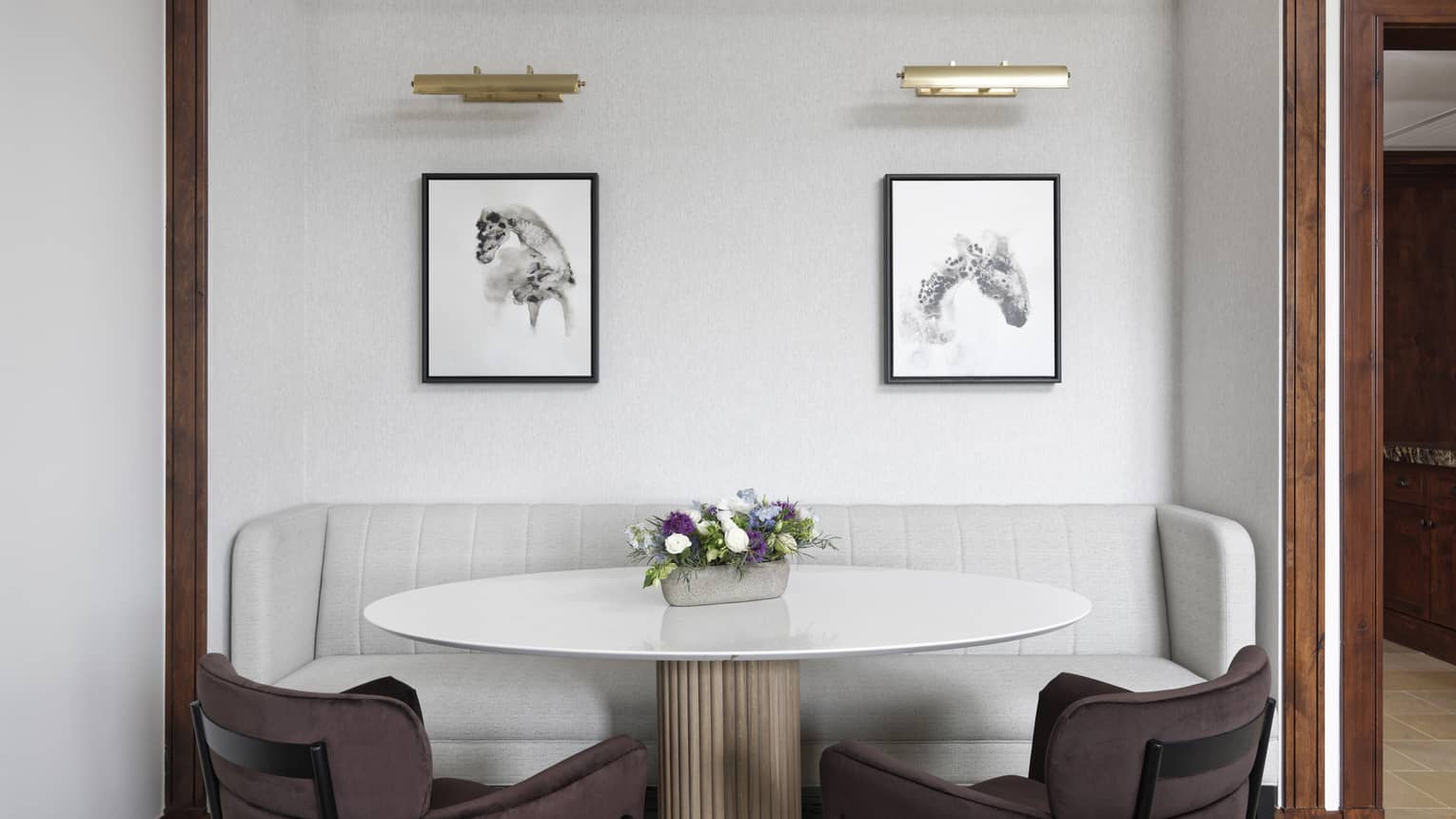 White round table with two chairs and sofa