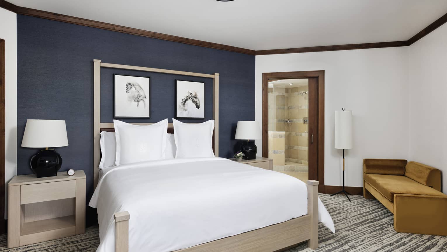 Bedroom with king bed and dark blue accent wall
