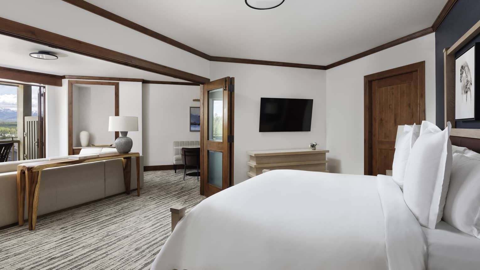 Bedroom with king bed and doors opening to living room