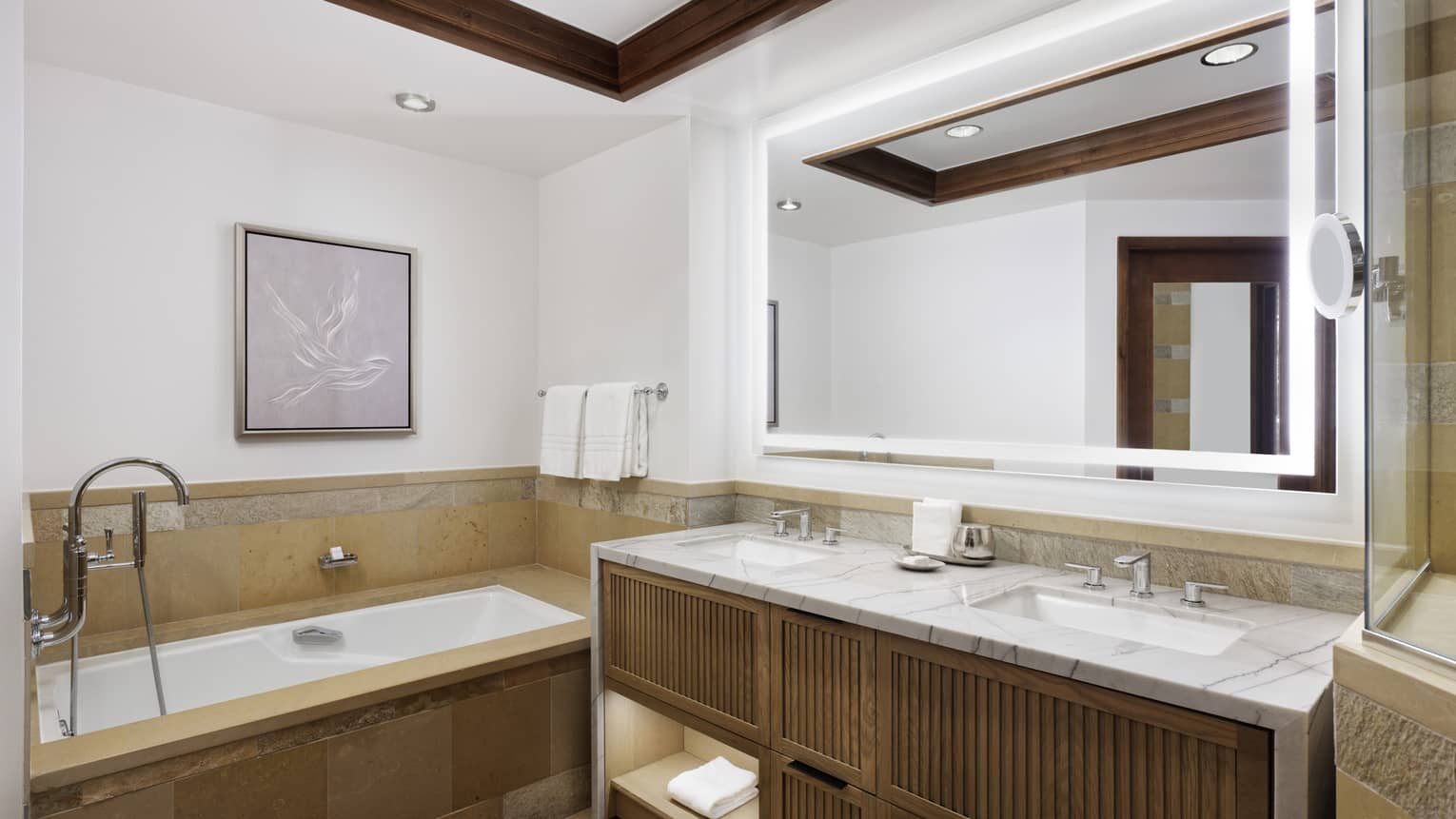 Bathroom with wood and marble vanity, tub