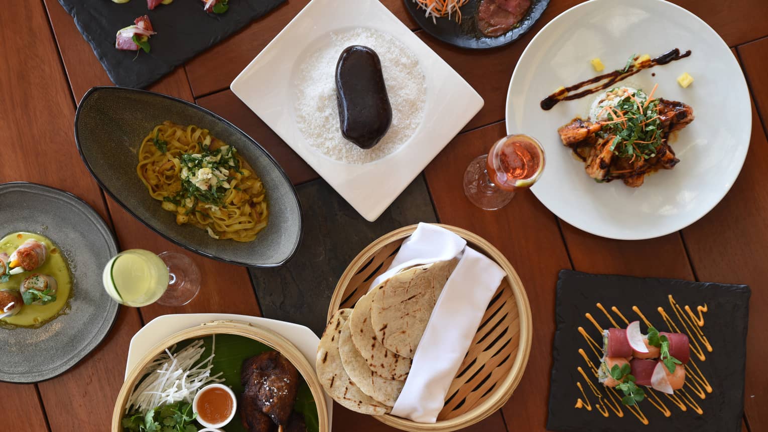 Aerial view of Aramara five-spiced half duck with chopped cilantro, coleslaw and grilled tortilla in baskets