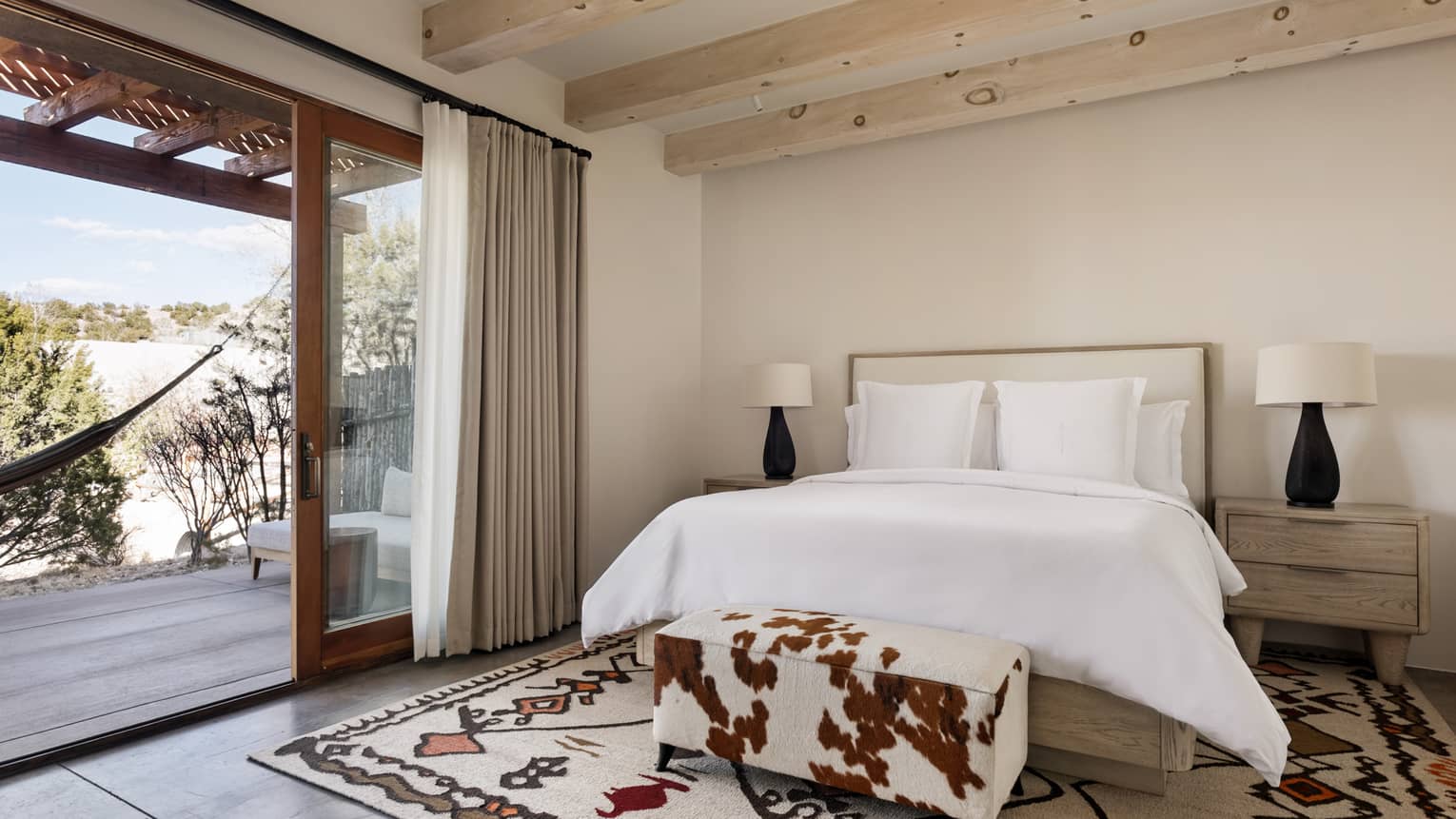 Guest room with king bed and walk-out terrace at Four Seasons Resort Santa Fe