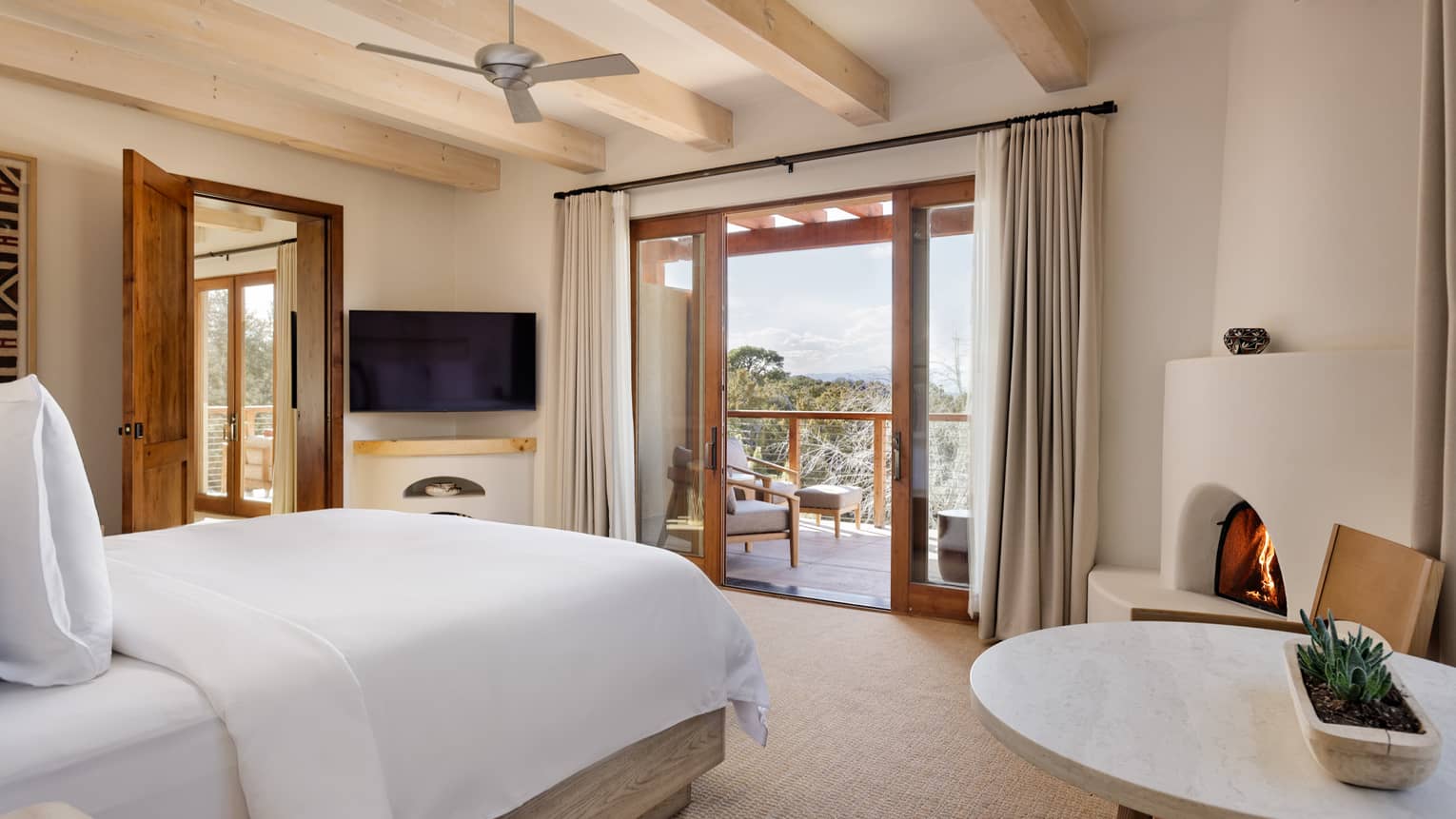 Guest bedroom with king bed, walk-out balcony and connecting room at Four Seasons Resort Santa Fe