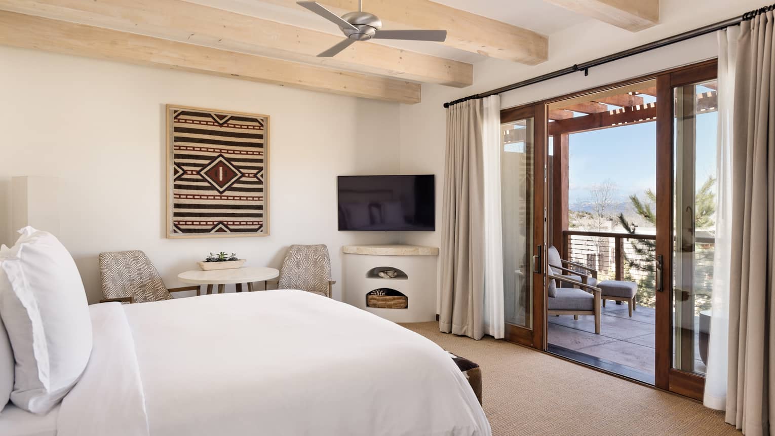 Guest room with king bed and walk-out terrace at Four Seasons Resort Santa Fe