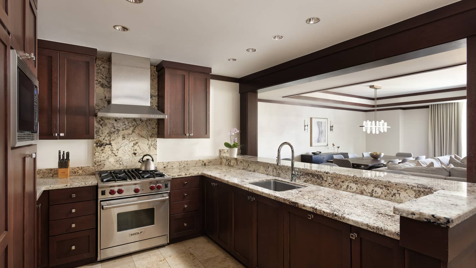 Kitchen with dark wood cabinets and opening to the living room