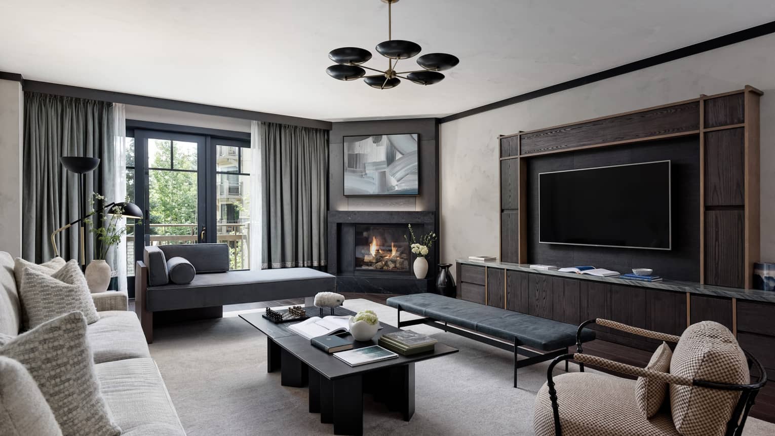 Contemporary living room of one-bedroom suite at Four Seasons Vail, with grey and black tones