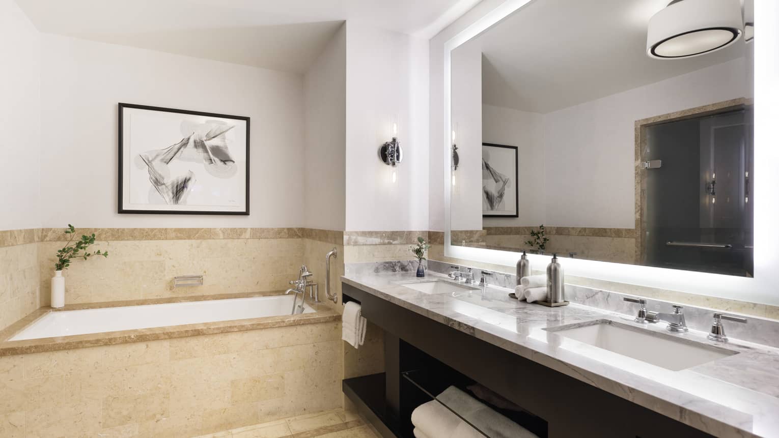 Bathroom of a hotel suite, with marble double vanity and separate tub
