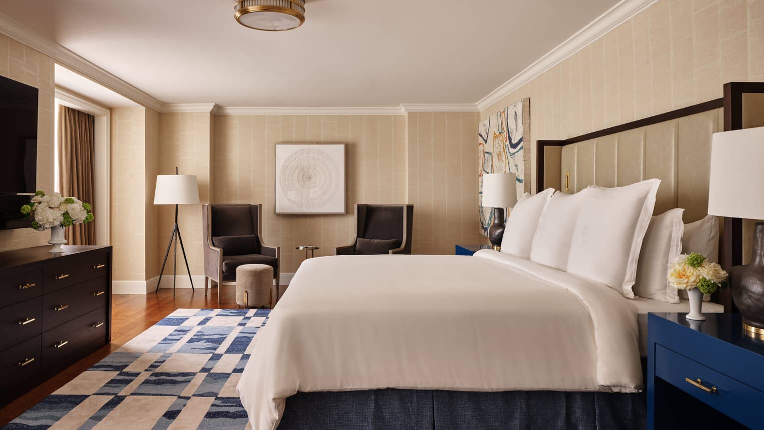 Contemporary luxury bedroom with king bed and blue-and-white area rug