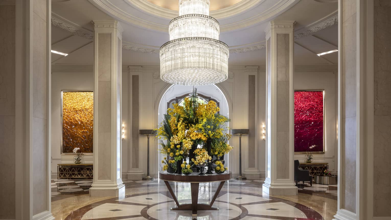 Grand lobby with large crystal chandelier and round table with huge floral centrepiece, at Beverly Wilshire, A Four Seasons Hotel