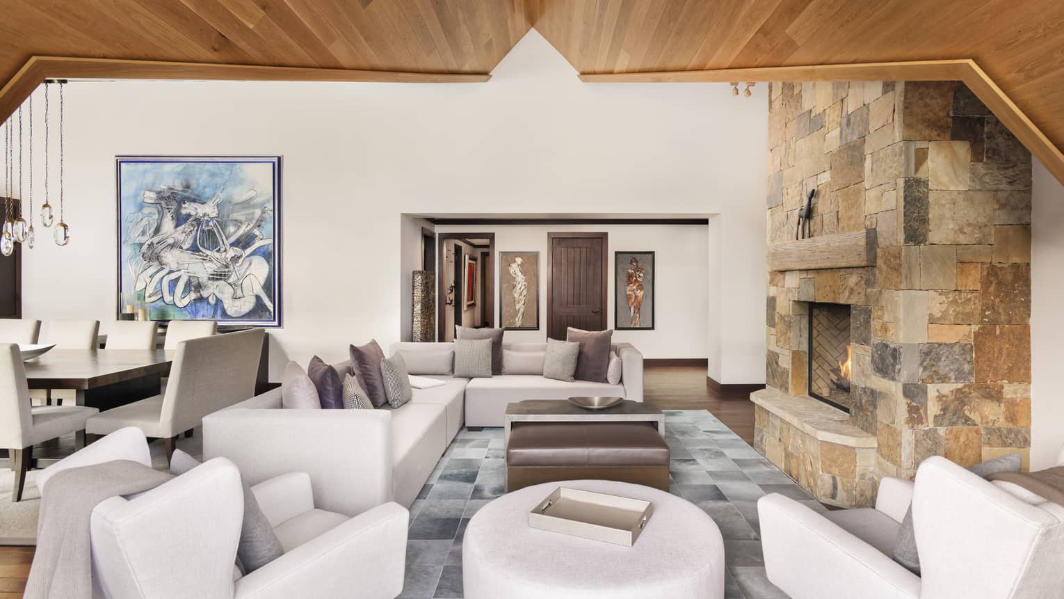 Living room with sectional sofa, two arm chairs and ottoman